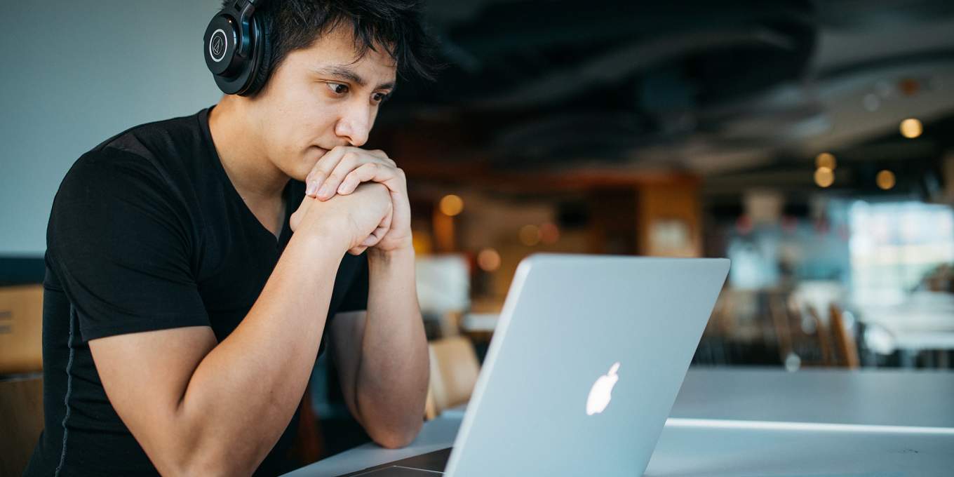 Man staring at laptop intently