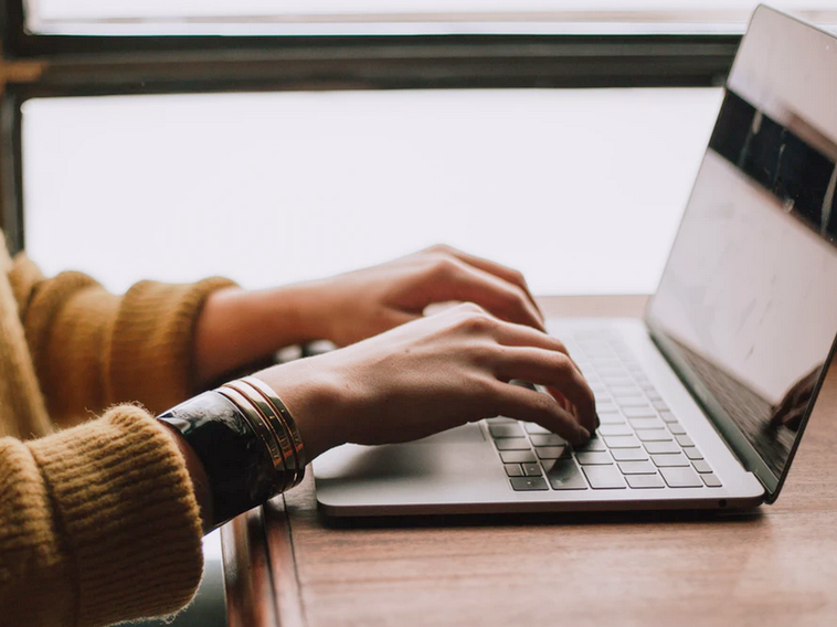Typing on a laptop