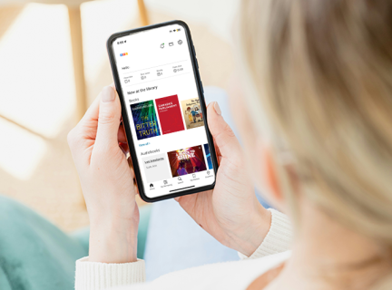 Woman looking at the VPL mobile app on a phone