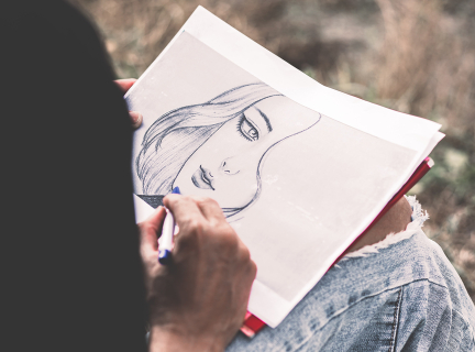 Teen sketching woman's face