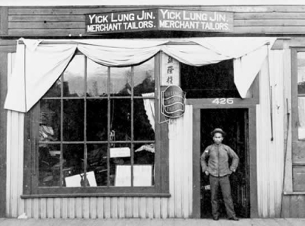 Man standing in forrway of Yick Lung Jin Tailors in c1900 Photo of Yick Lung Jin Tailors, c1900, Vancouver, B.C. VPL 9498