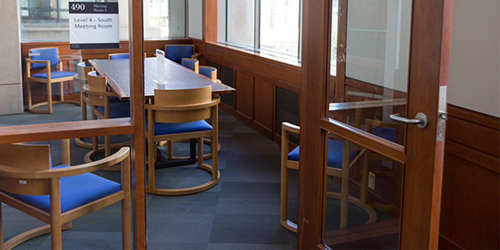 The Central Library L4 South meeting room The Central Library L4 South meeting room looking through the door. There is one rectangular table surrounded by six chairs and an additional chair in each of the corners facing inward.