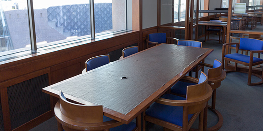 The Central Library L6 South meeting room The Central Library L6 South meeting room looking towards the door. There is one rectangular table surrounded by six chairs and two additional chairs facing towards the camera on either side of the door.
